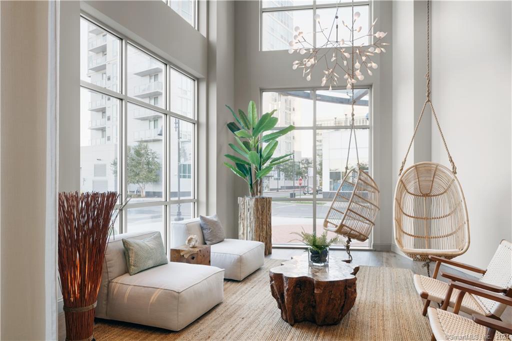 850 Pacific Street, Unit 448 Stamford, CT 06902 - Photo 2 of 16 a living room with furniture and a potted plant