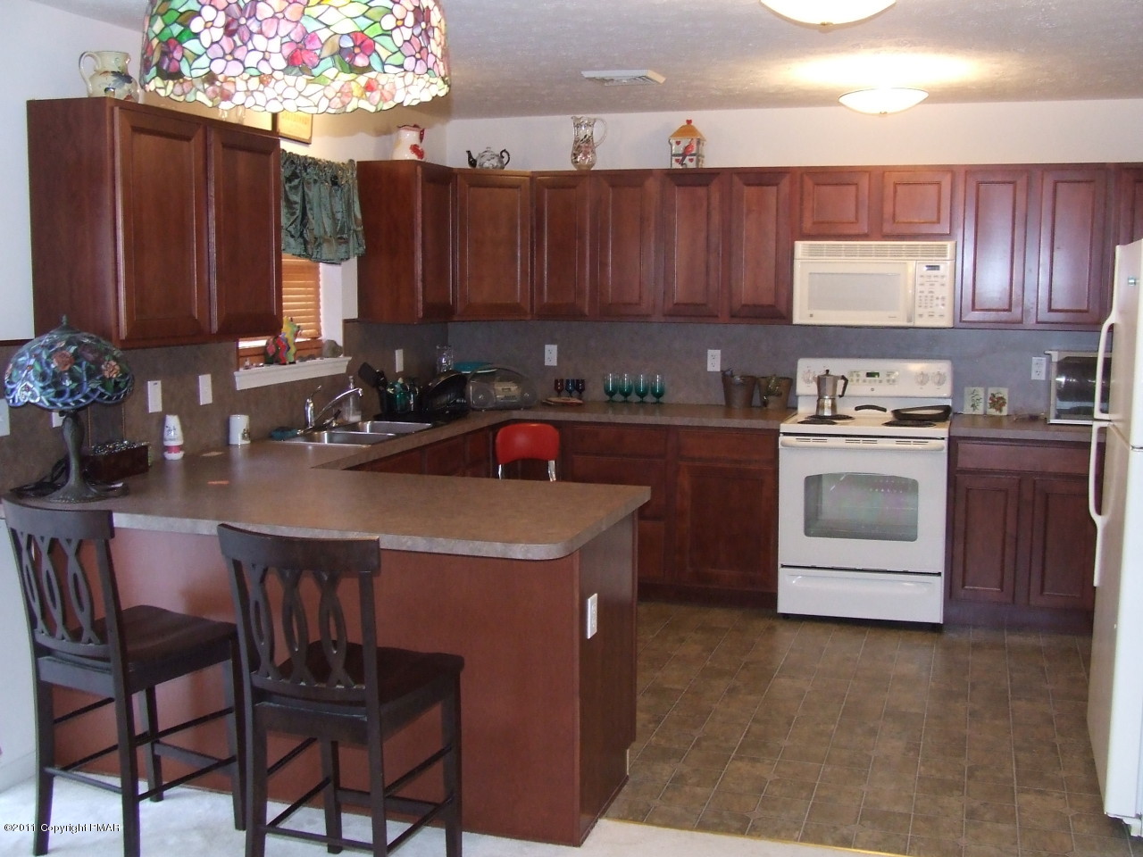 2317 Clover Road Long Pond, PA 18334 - Photo 3 of 14 a kitchen with a sink a stove and wooden cabinets
