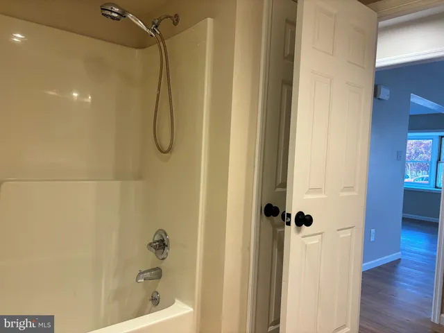 a bathroom with a glass shower door