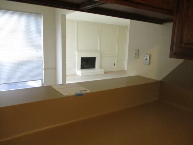 a view of an empty room with a fireplace