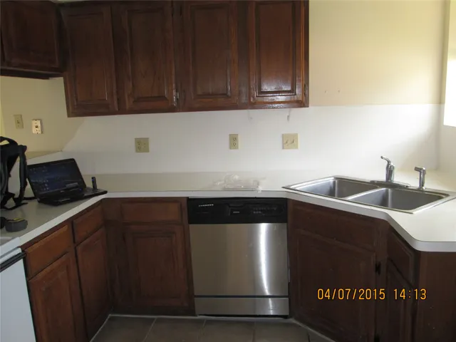 a kitchen with granite countertop a sink and cabinets
