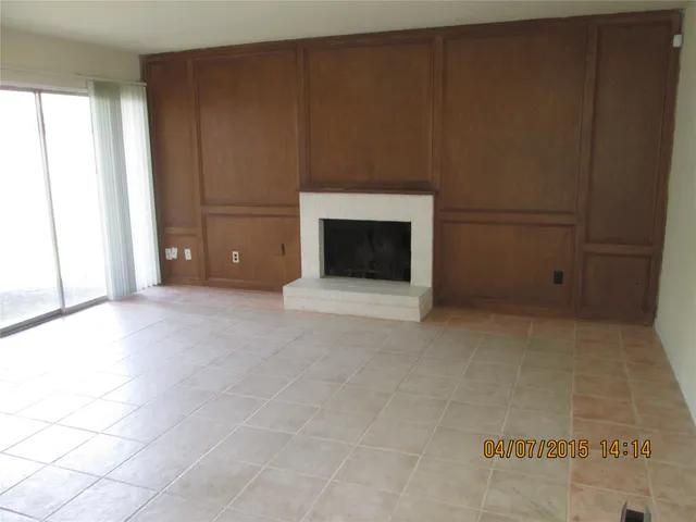 a view of an empty room with a fireplace
