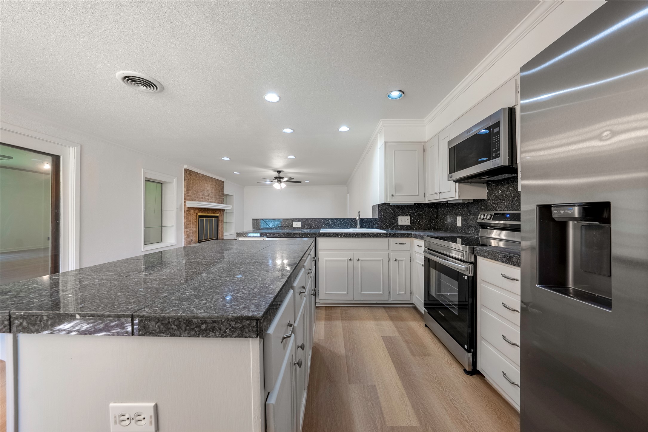 807 Country Club Road Georgetown, TX 78628 - Photo 6 of 28 a kitchen with stainless steel appliances granite countertop a sink and a stove