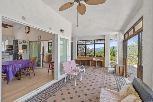 a view of a hallway with living room and dining room