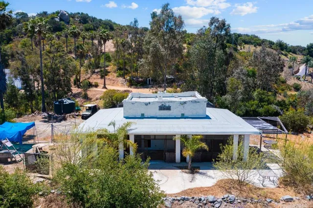 a view of a house with a yard and porch