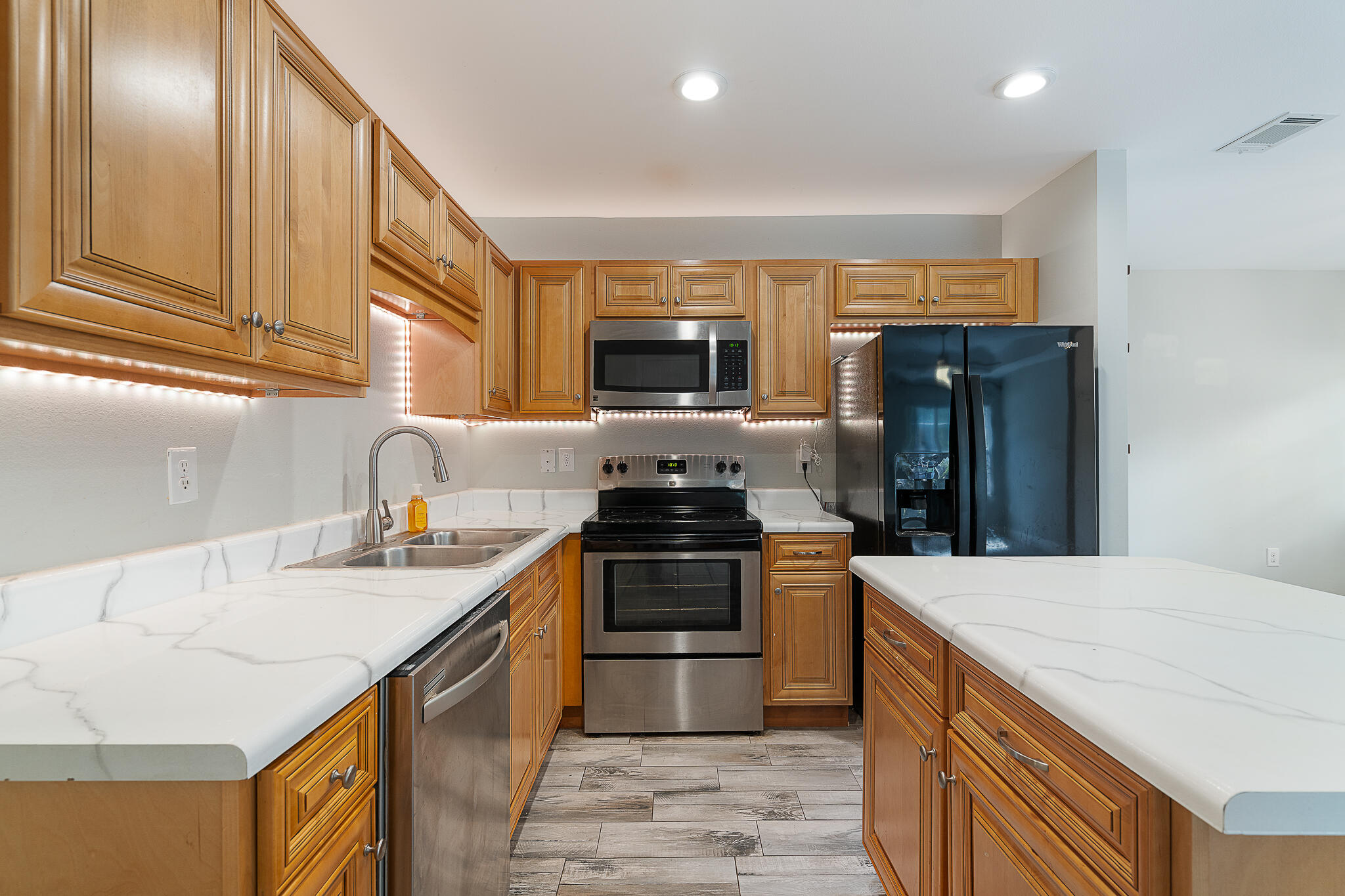 202 Mc Arthur Street Crestview, FL 32539 - Photo 11 of 39 a kitchen with a stove and a refrigerator