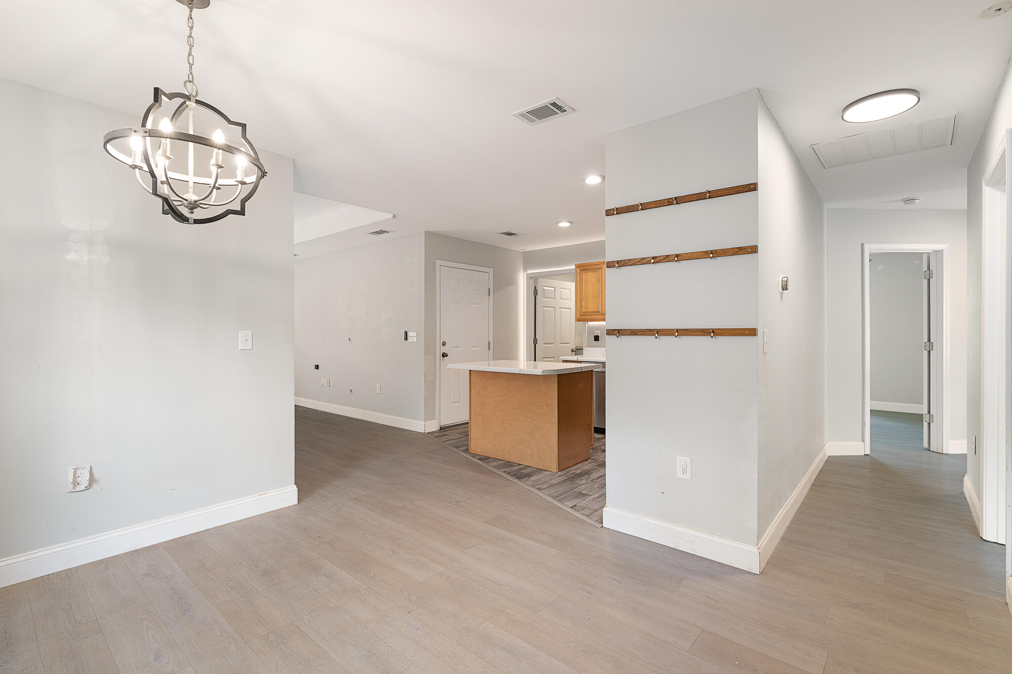 202 Mc Arthur Street Crestview, FL 32539 - Photo 13 of 39 a view of a kitchen with a refrigerator and microwave