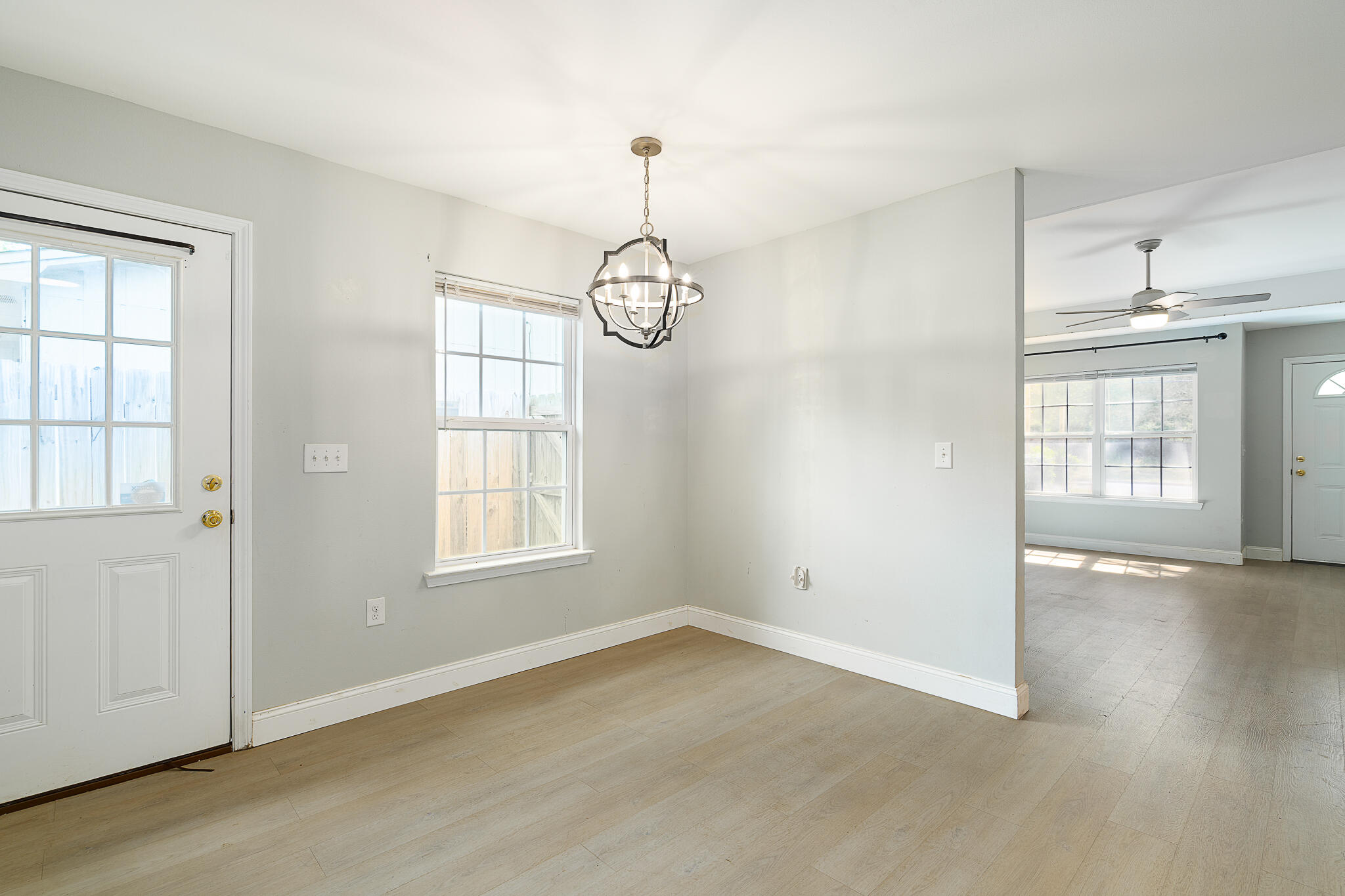 202 Mc Arthur Street Crestview, FL 32539 - Photo 14 of 39 an empty room with wooden floor and windows