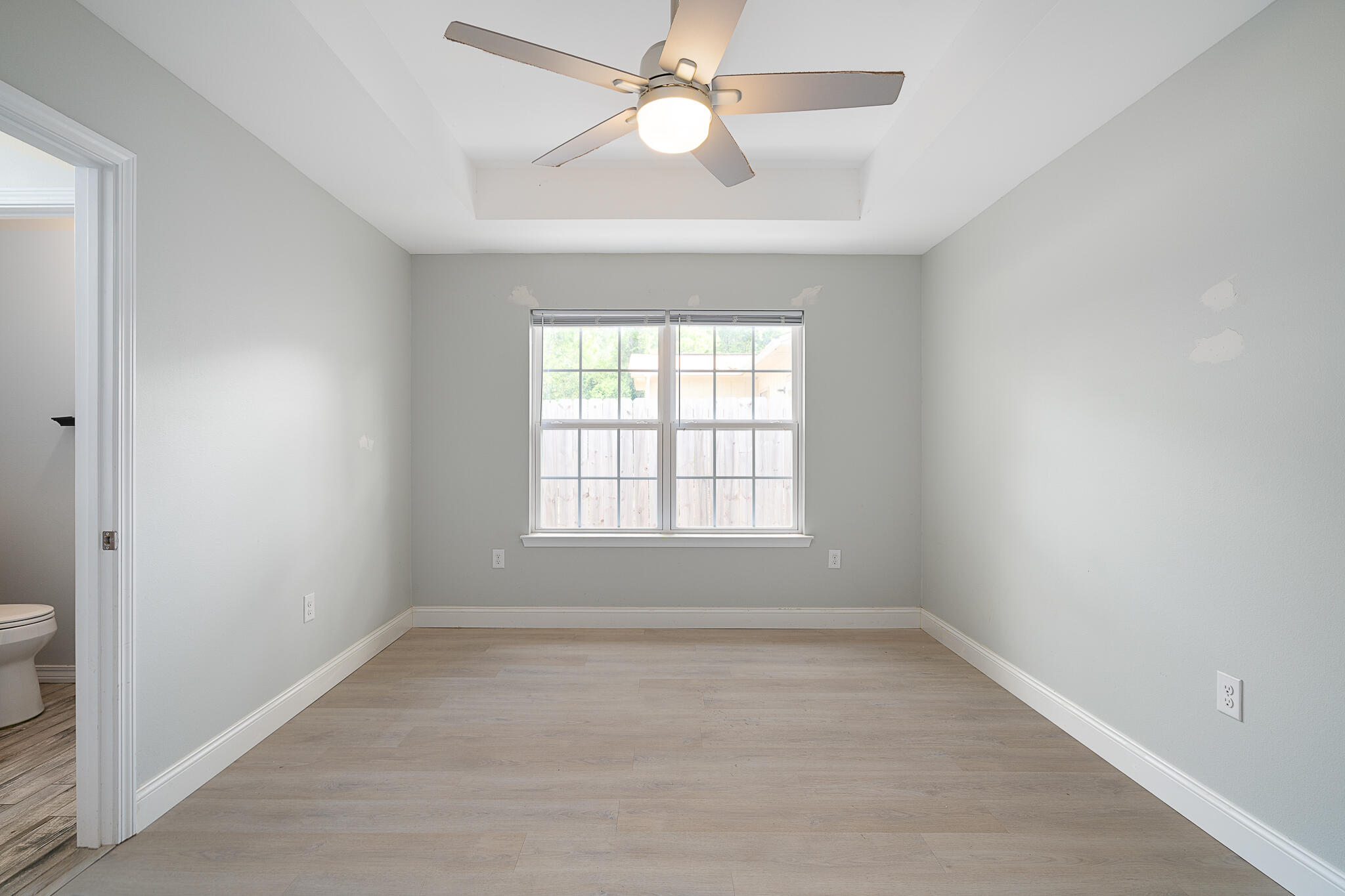 202 Mc Arthur Street Crestview, FL 32539 - Photo 17 of 39 wooden floor in an empty room with a window