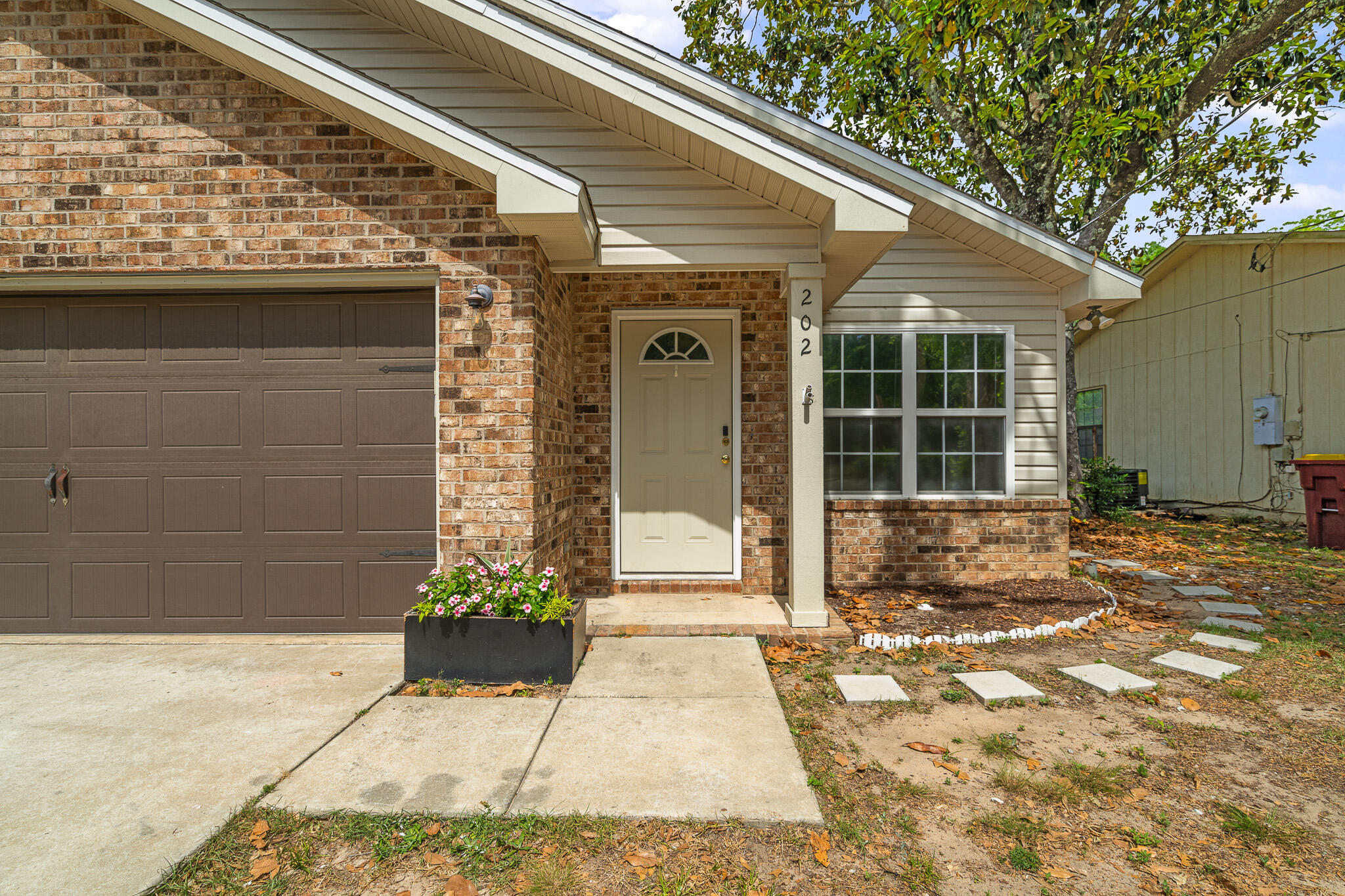 202 Mc Arthur Street Crestview, FL 32539 - Photo 3 of 39 a front view of a house with a yard
