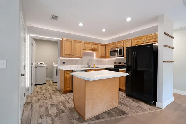a kitchen with a stove a refrigerator and a refrigerator