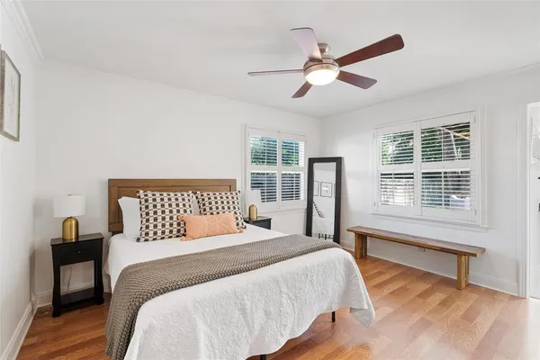 a bedroom with a large bed and a large window