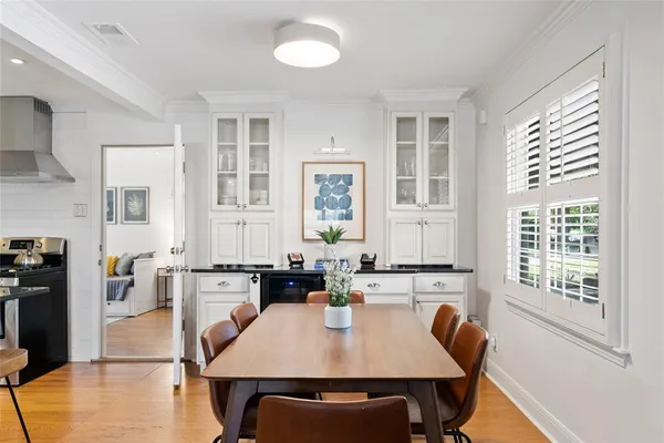 a view of a a dining room with furniture window and wooden floor