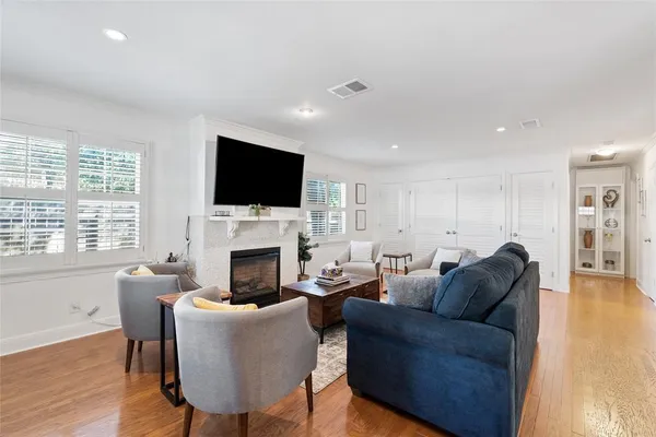 a living room with furniture a fireplace and a flat screen tv