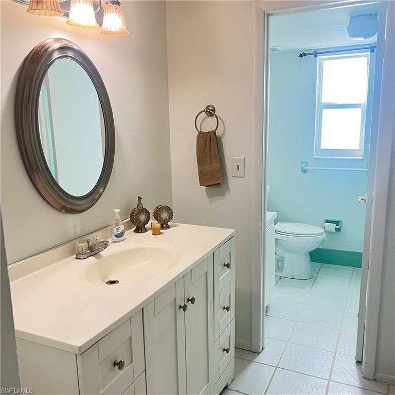 197 Harrison Road, Unit 3 Naples, FL 34112 - Photo 9 of 14 Bathroom with light tile patterned flooring and vanity
