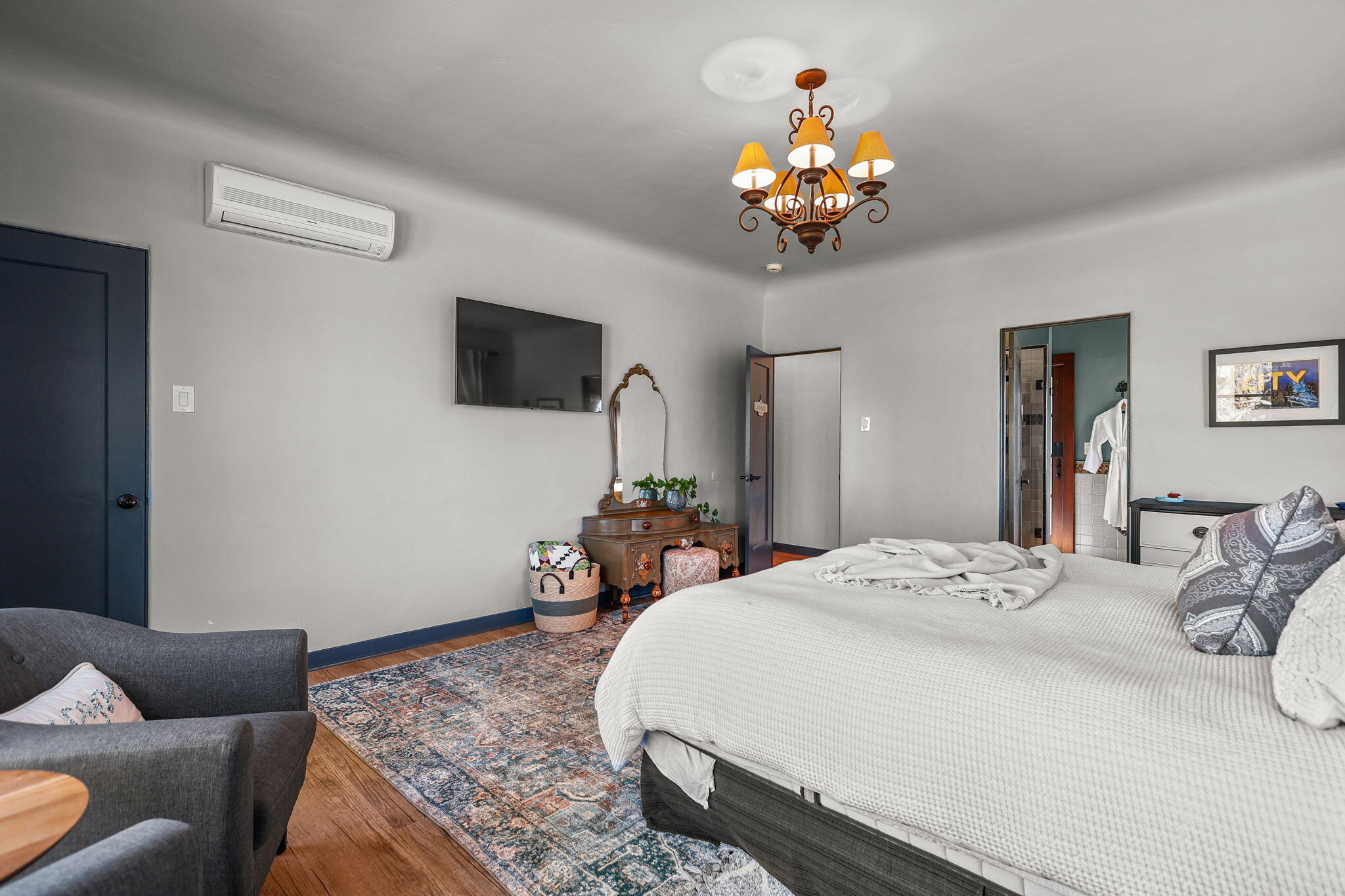 1465 Riverside Drive Redding, CA 96001 - Photo 100 of 163 a bedroom with a bed chandelier and a flat screen tv