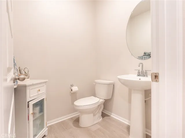 a kitchen with a sink cabinets and wooden floor