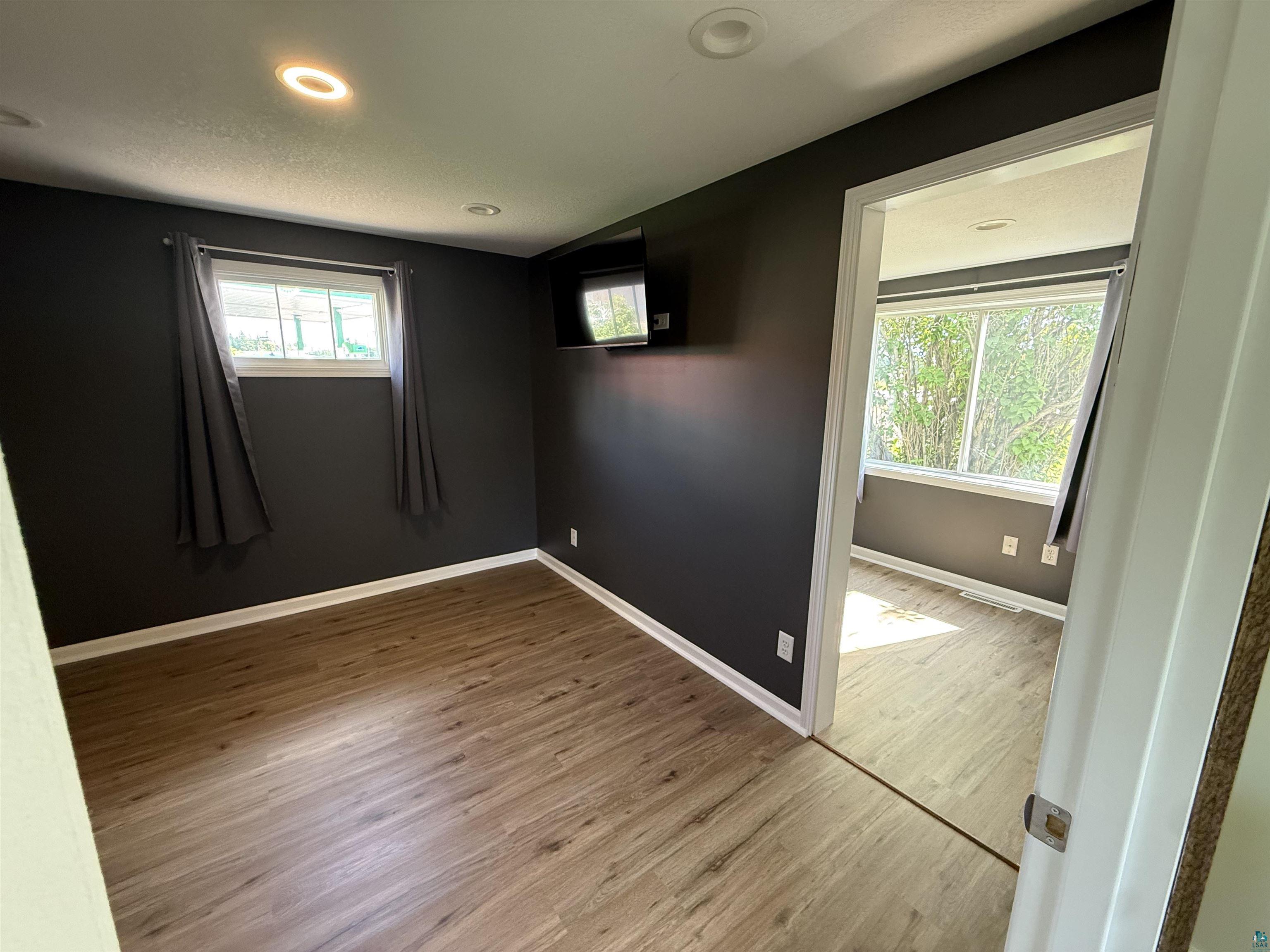 3841 Haines Road Hermantown, MN 55811 - Photo 6 of 11 Interior room featuring wood-finish flooring, recessed ceiling lighting, and a white-trimmed window