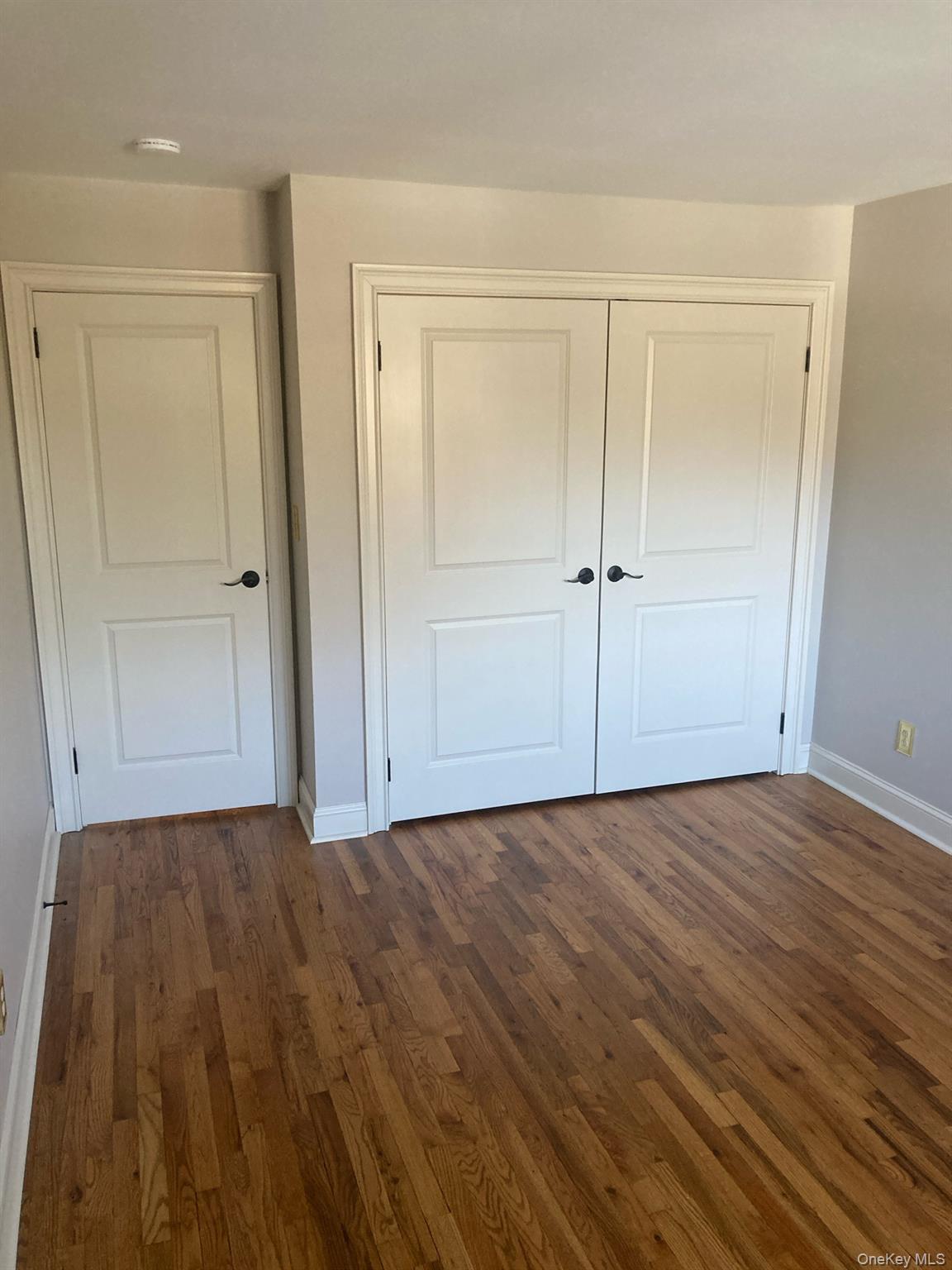 2 Colonial Road, Unit 126 Beacon, NY 12508 - Photo 6 of 11 Unfurnished bedroom with dark wood-type flooring and a closet