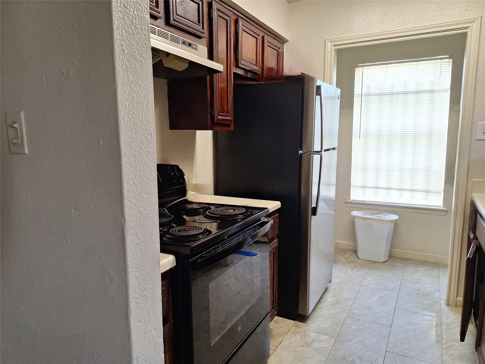 1327 Brenda Lane Humble, TX 77338 - Photo 10 of 12 a kitchen with stainless steel appliances granite countertop a refrigerator and a stove