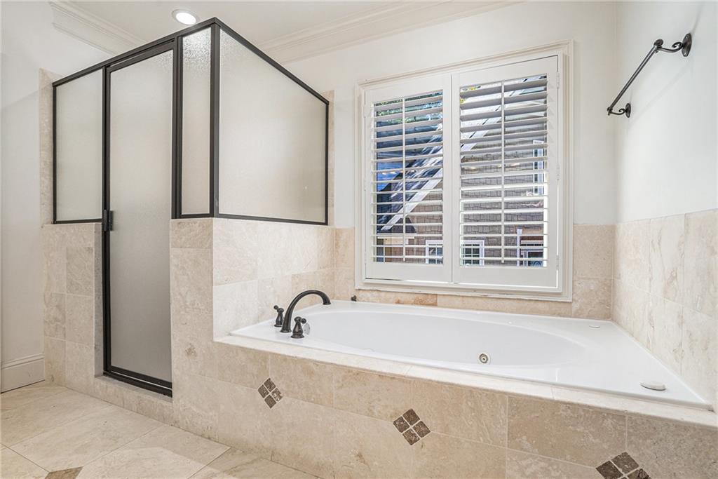 3301 Chastain Ridge Drive Marietta, GA 30066 - Photo 25 of 50 a bathroom with a bathtub and shower