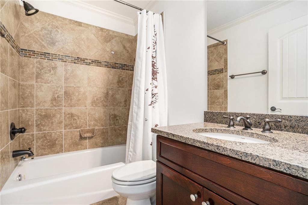 3301 Chastain Ridge Drive Marietta, GA 30066 - Photo 32 of 50 a bathroom with a granite countertop sink a toilet and shower