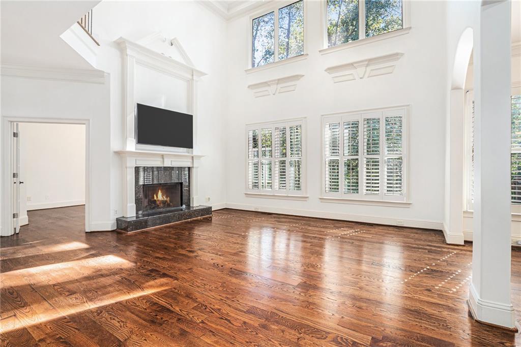 3301 Chastain Ridge Drive Marietta, GA 30066 - Photo 8 of 50 a view of an empty room with wooden floor fireplace and a window