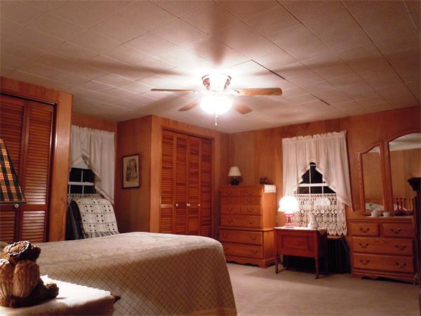29 Putnam Road Sturbridge, MA 01566 - Photo 9 of 19 a bedroom with a large bed and a chandelier