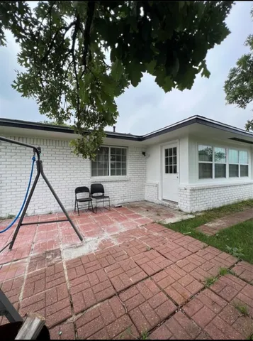 a backyard of a house with table and chairs