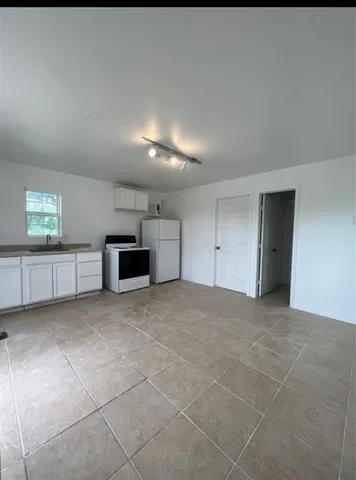 a view of an empty room and a window