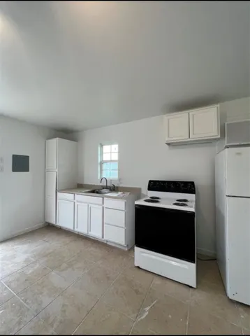 a kitchen with stainless steel appliances granite countertop a stove a microwave and a refrigerator