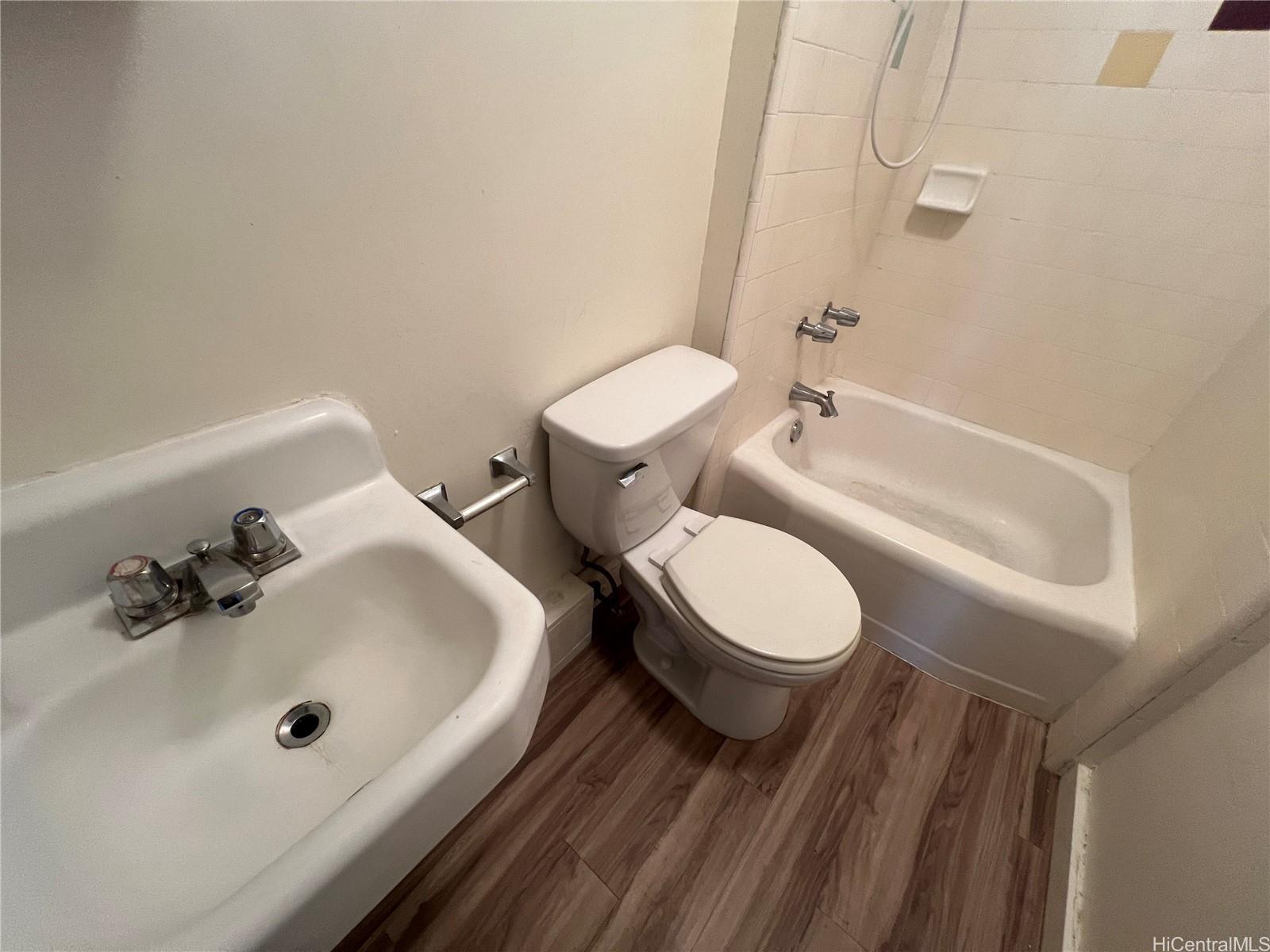 3121 Herbert Street, Unit 101 Honolulu, HI 96815 - Photo 4 of 6 a bathroom with a sink mirror vanity and toilet