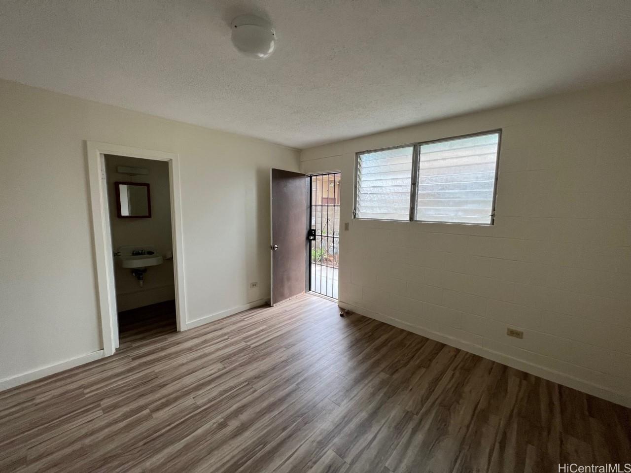 3121 Herbert Street, Unit 101 Honolulu, HI 96815 - Photo 6 of 6 wooden floor in an empty room with a window
