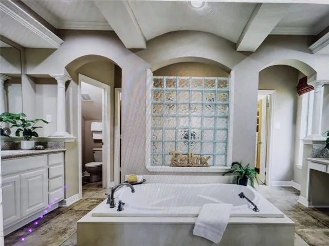 a living room with fireplace furniture and a potted plant