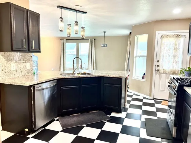 a kitchen with a sink a counter and cabinets