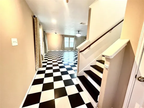 a view of a bathroom with a black and white checkered floor