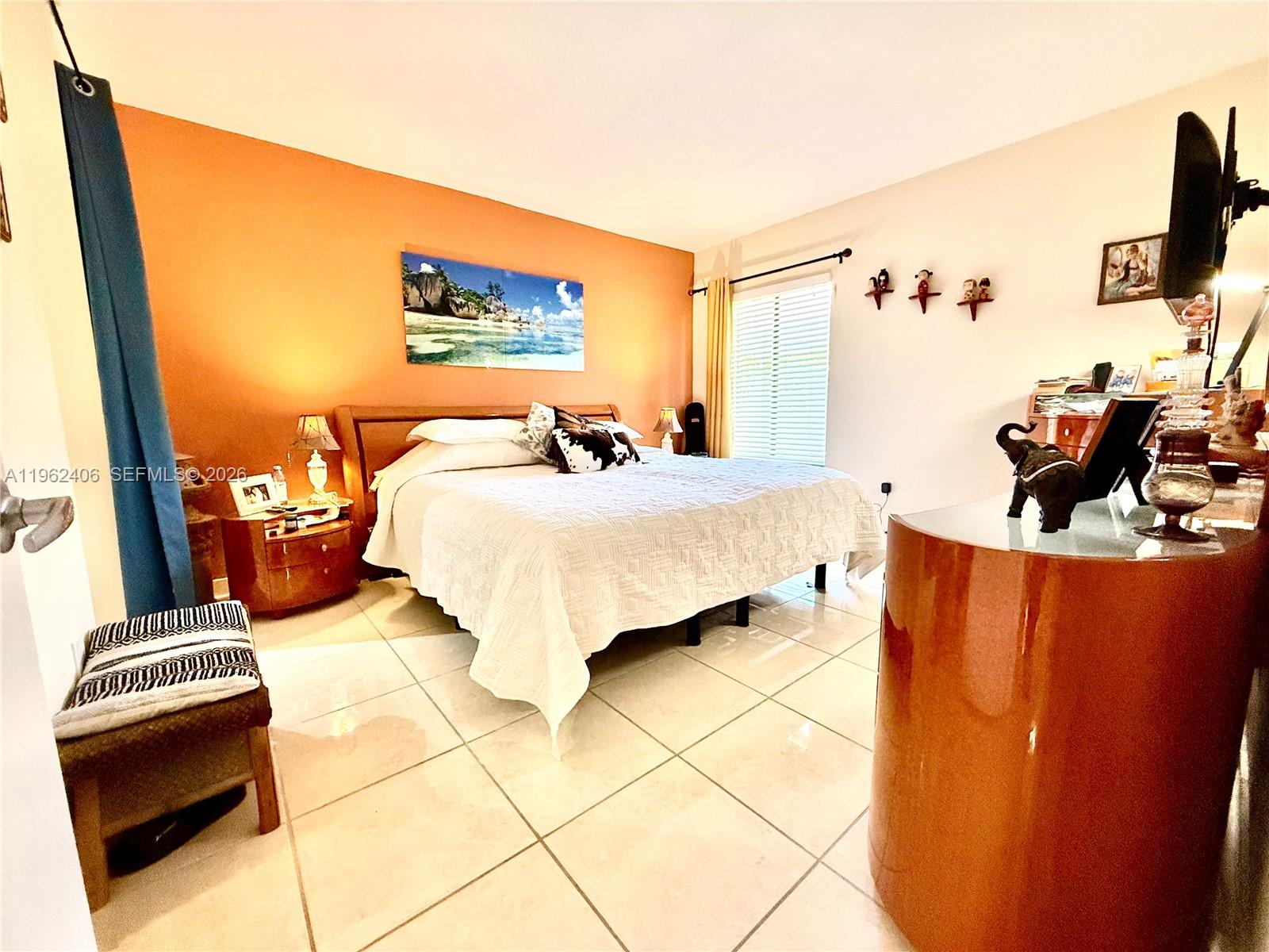 351 Club Circle, Unit 102 Boca Raton, FL 33487 - Photo 18 of 34 a bedroom with a bed and wooden floor