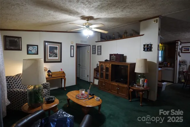 a living room with furniture and a dining table with wooden floor