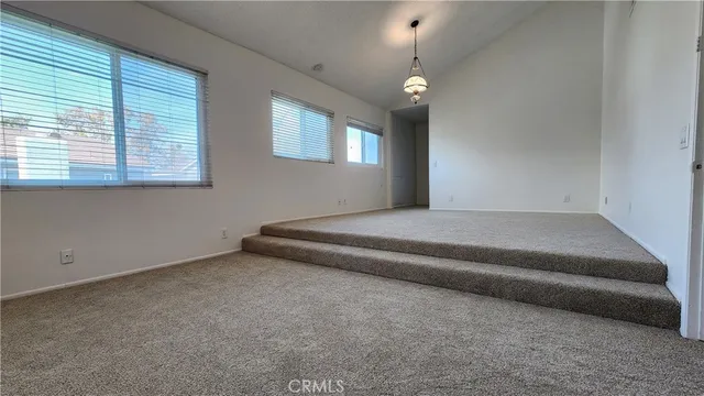 a spacious bedroom with a bed and a window