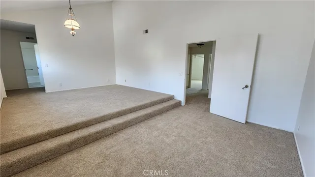 a view of a big room with chandelier fan