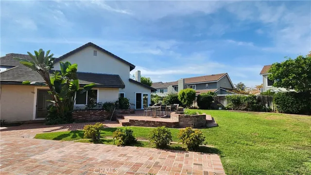 a view of a yard with plants and trees