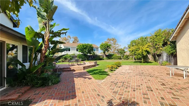 a view of a backyard with sitting area