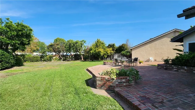 a view of a backyard with sitting area