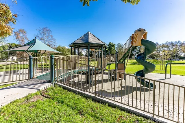 a view of a park with plants and large trees