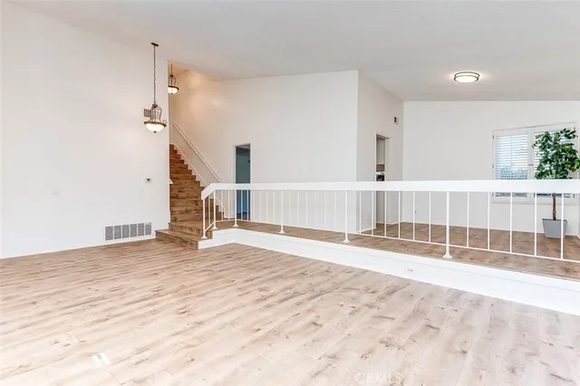 a view of wooden floor and windows in a room
