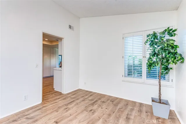a view of a livingroom with wooden floor and a potted plant