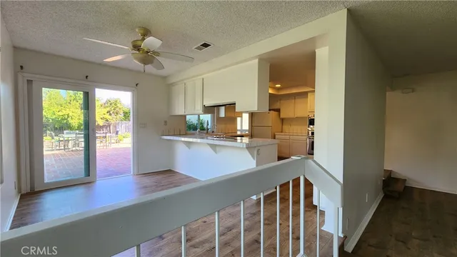a view of kitchen with sink and wooden floor