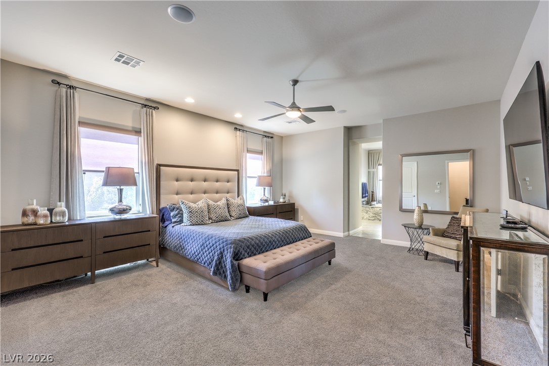 7119 Arabian Ridge Street Las Vegas, NV 89131 - Photo 26 of 73 Comfort and design converge in this bedroom with a plush bed, ample natural light, and elegant ceiling fan.