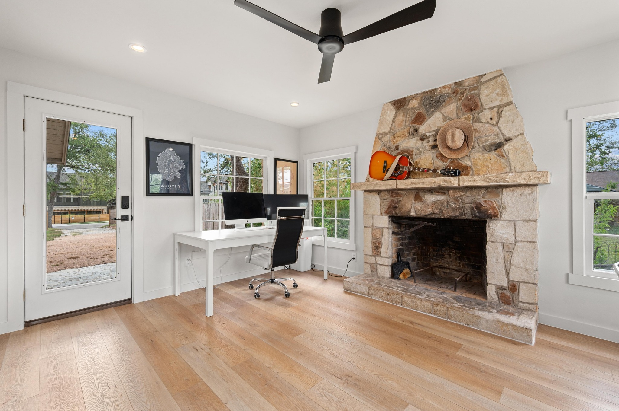 3501 Pecan Springs Road Austin, TX 78723 - Photo 25 of 40 Office space featuring a fireplace, hardwood / wood-style flooring, ceiling fan, and recessed lighting