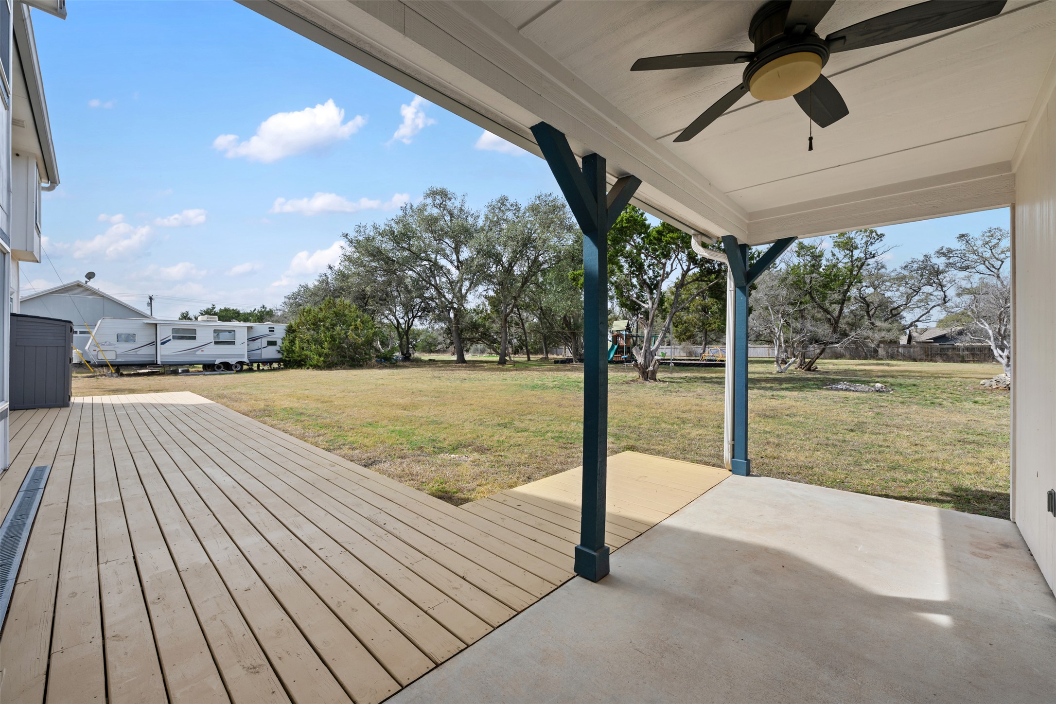 104 Sunset Road Georgetown, TX 78633 - Photo 34 of 40 Wooden terrace with a ceiling fan, a yard, and a patio